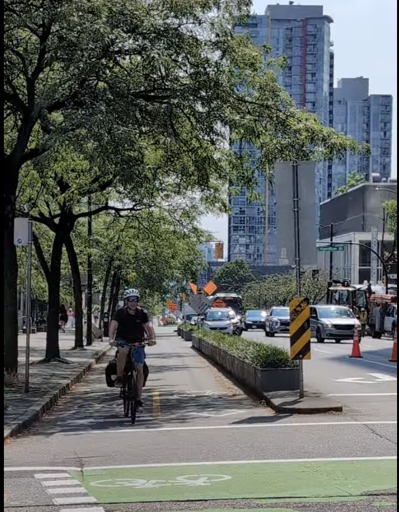 Shaded green complete street with trees and protected bike facilities